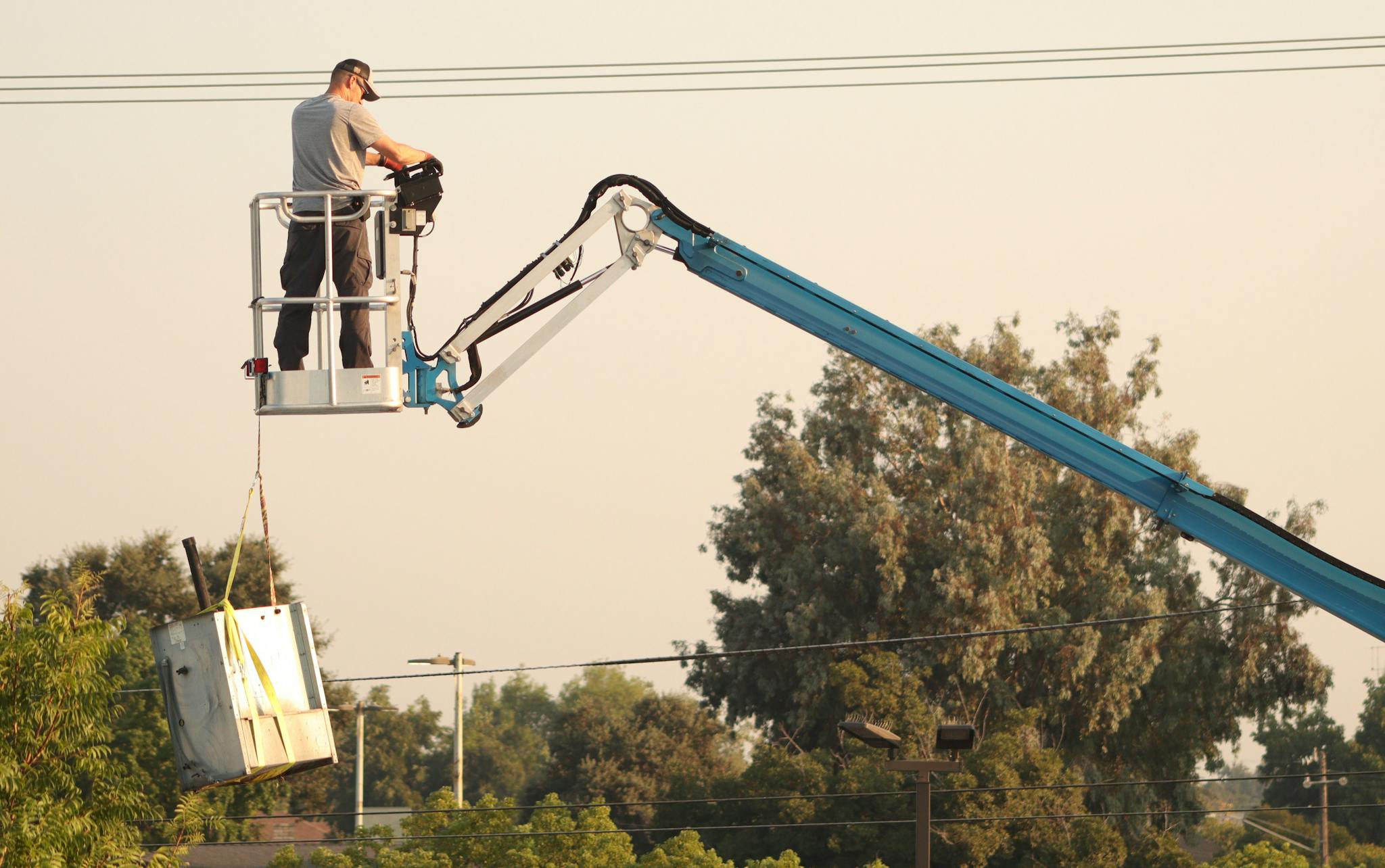 About Man In A Cherry Picker Operating Machinery